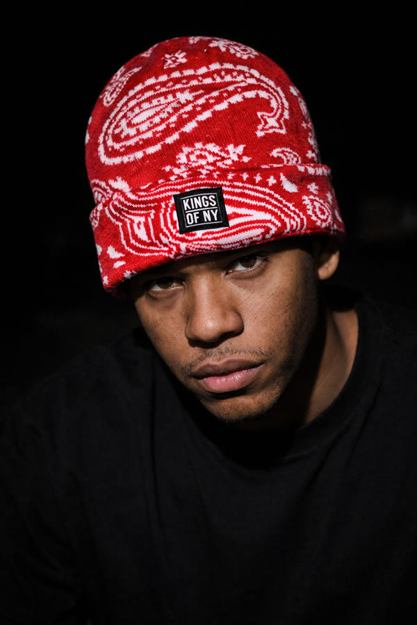 Person wearing a red bandana with white patterns and 'Kings of NY' logo on a black background