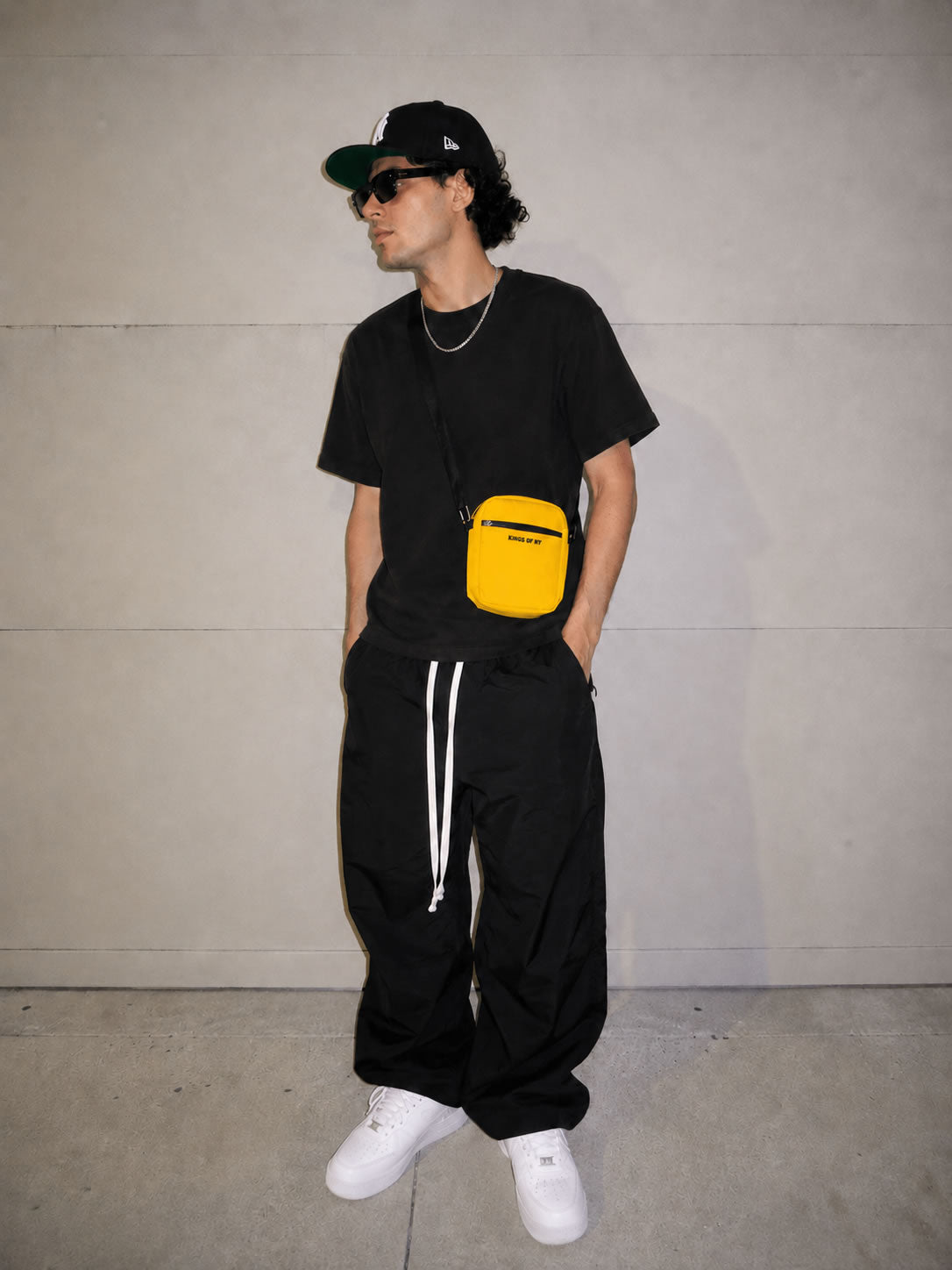 Modeal wearing Men's Core Yellow Crossbody Bag by Kings Of NY